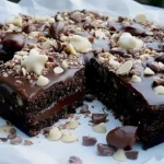Schokoladiger Blechkuchen mit Mandeln, frisch gebacken und dekoriert.